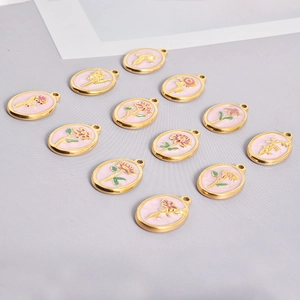Macro detail of oval pink enamel flower pendants with gold plating for DIY jewelry
