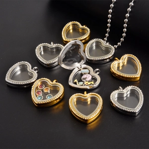 Heart-shaped floating locket in gold and silver with rhinestones and clear glass windows