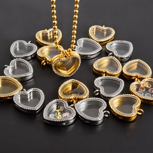 Detail of heart-shaped stainless steel locket pendants with rhinestones and clear glass