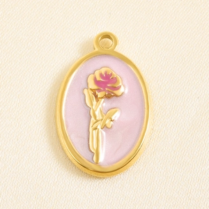 Detail of oval golden stainless steel pendant with pink enamel and rose flower relief