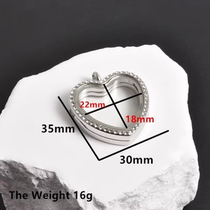 Detail showing heart-shaped silver stainless steel locket with 30mm glass frame and stones