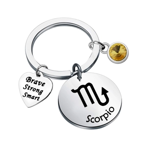Macro shot of stainless steel Scorpio keychain with engraved heart and yellow birthstone