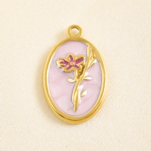 Macro shot of oval gold-plated floral pendant with pink enamel for DIY necklace making