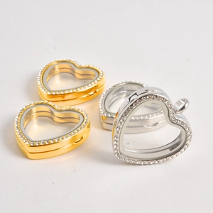 Macro shot of heart-shaped floating charm lockets with crystal borders in gold and silver