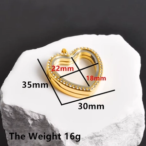 Detail of heart locket pendant with gold finish, sparkling rhinestones and clear glass window