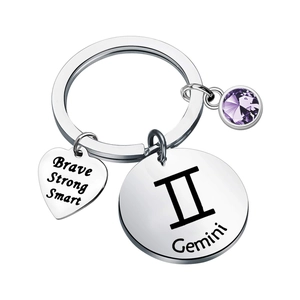 Macro shot of Gemini zodiac keychain with heart pendant and purple crystal stone