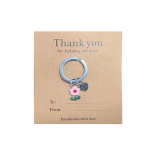 Floral thank you keyring with pink flower and heart charm on greeting card background