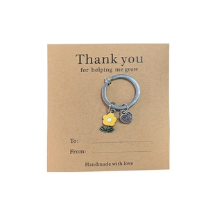 Silver keyring with yellow flower and engraved heart on thank you helping me grow gift card