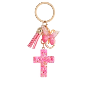 Pink resin cross keychain with gradient butterfly, tassel, and gold-tone metal ring