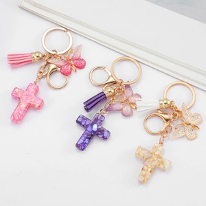 Handmade butterfly and resin cross keychain with leather tassel in pink, purple and white