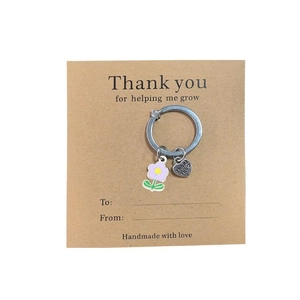 Floral keyring with purple flower and engraved Thank You heart on brown card backing