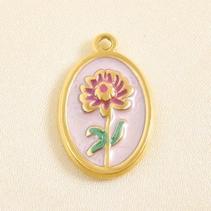 Macro detail of oval pink enamel flower pendant with gold metal edges for DIY necklaces