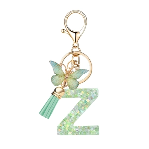 Letter Z keychain with green resin pendant, butterfly charm and mint green tassel on white background