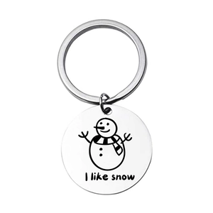 Detail of round silver keychain showing a cute snowman and I like snow engraving