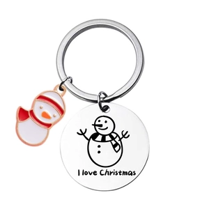 Close-up of stainless steel Christmas keychain with snowman charm and engraved circular tag