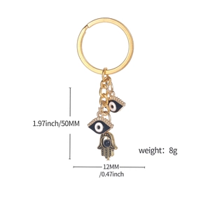 Golden Evil Eye and Hamsa Hand keychain with dimensions 50mm height and 8g weight