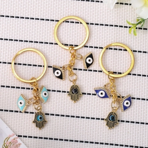Hamsa Hand and Evil Eye metal keychains in light blue, black and dark blue finishes