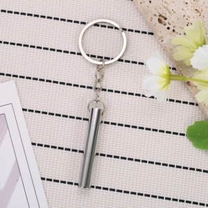 Polished titanium steel mindfulness breathing whistle keychain in a silver finish