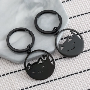 Set of two matte black stainless steel keychains with hollow out cat head silhouette