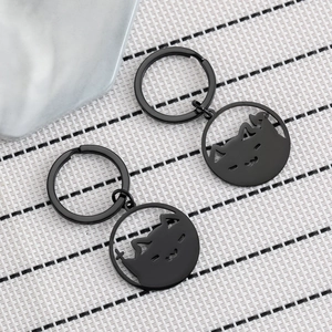 Pair of minimalist black stainless steel keychains with hollow cat face cutout design