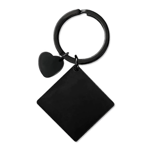 Close-up of matte black stainless steel heart and diamond shaped charms on keychain