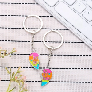 Gradient color Best Friends heart puzzle keychain set on a stylish desktop setup