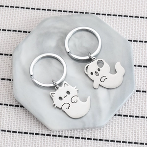 Cute ghost cat and bear stainless steel keychains displayed on a marble tray