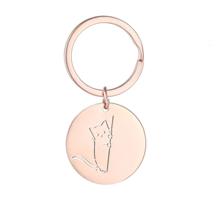 Dettaglio di un portachiavi in oro rosa con gatto inciso al laser sul ciondolo circolare