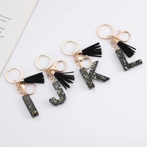 Black resin alphabet keychain set with gold glitter and elegant black tassels