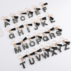 Set of 26 black resin alphabet keychains with gold glitter, black tassels and gold rings