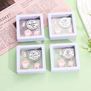 Baby decision coin set with pink enamel charms and mummy's turn coin in display boxes