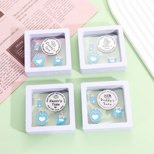 New parent decision coin set with blue charms in a white film jewelry display box