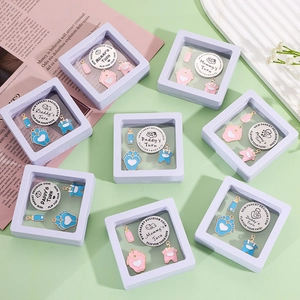 Double-sided stainless steel baby decision coin set in floating display box with charms