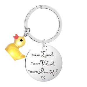 Vue macro d'un porte-clés inspirant argenté avec un petit pendentif canard jaune