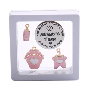 Pink enamel baby charm set and decision coin in a white PE film display box