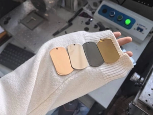 Polished stainless steel dog tags in rose gold, silver, gunmetal, and gold finishes