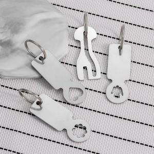 Stainless steel shopping trolley tokens with heart and angel designs on a striped background