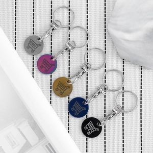 Five colorful stainless steel supermarket trolley tokens with shopping cart icons