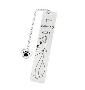 Macro detail of stainless steel bookmark featuring cat engraving and heart paw pendant charm