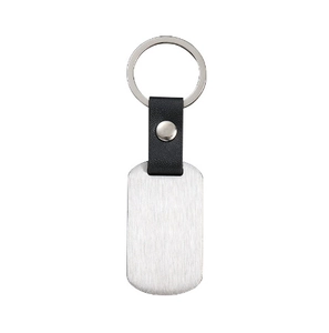 Close-up of rectangle brushed stainless steel tag and black leather keychain loop