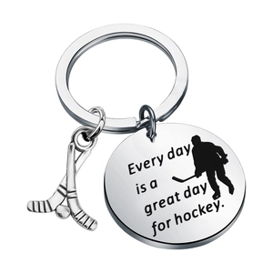Polished stainless steel hockey keychain with crossed sticks and motivational quote