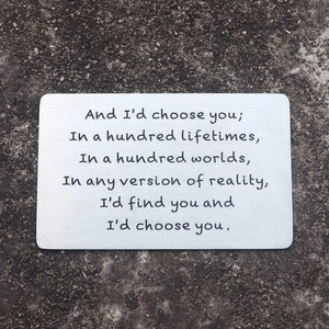 Laser engraved stainless steel wallet insert card with romantic poem on asphalt background
