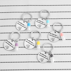 Stainless steel motivational keychains with colorful pill charms and engraved quotes