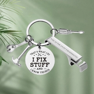 Macro detail of multi-tool keychain with stainless steel hammer and bottle opener charms