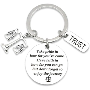Stainless steel lawyer keychain with justice scale and engraved trust tag on white background