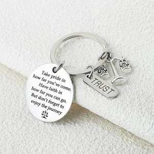 Detail of stainless steel lawyer keychain with scales of justice and trust charm