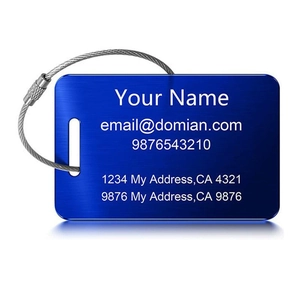 Macro view of blue brushed metal luggage tag with steel wire loop and personalized text