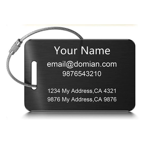 Detail of black brushed luggage tag with silver wire cable and personalized text