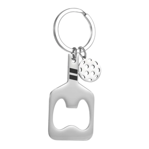 Stainless steel pickleball paddle keychain bottle opener with a mini ball charm on white background