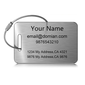 Close-up of brushed stainless steel luggage tag with wire cable and laser engraving